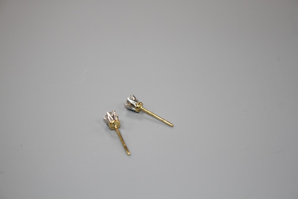 A pair of yellow metal and solitaire diamond earstuds, butterflies stamped 375, gross weight 1.1 grams,